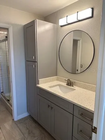 a bathroom with a double vanity sink and a mirror