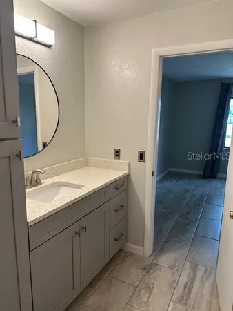 a bathroom with a sink and a mirror