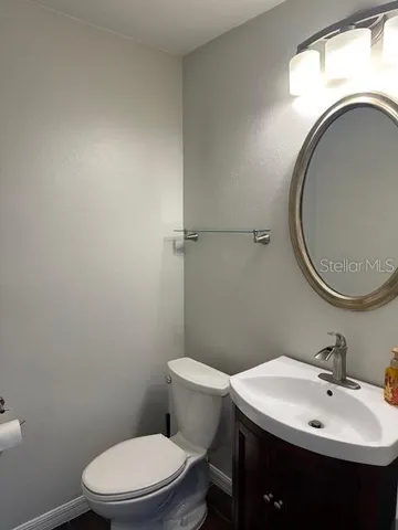 a bathroom with a sink a toilet and a mirror