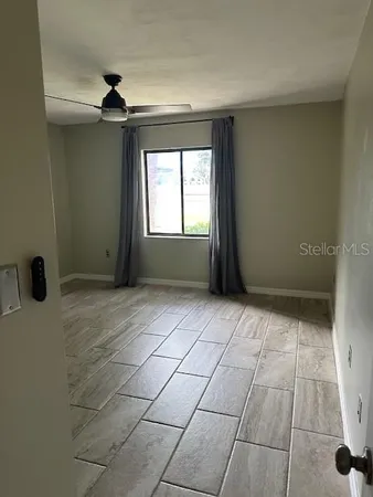 an empty room with a empty space and windows