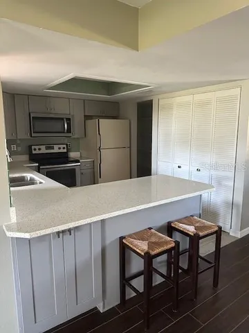 a kitchen with stainless steel appliances a stove a sink and a refrigerator