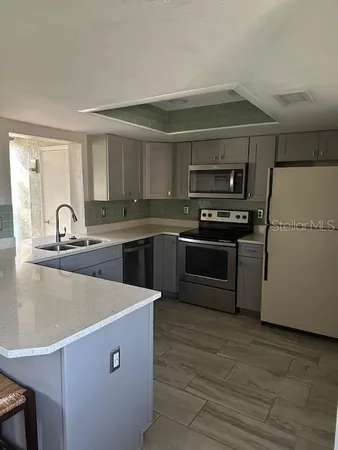 a kitchen with stainless steel appliances a sink and a stove