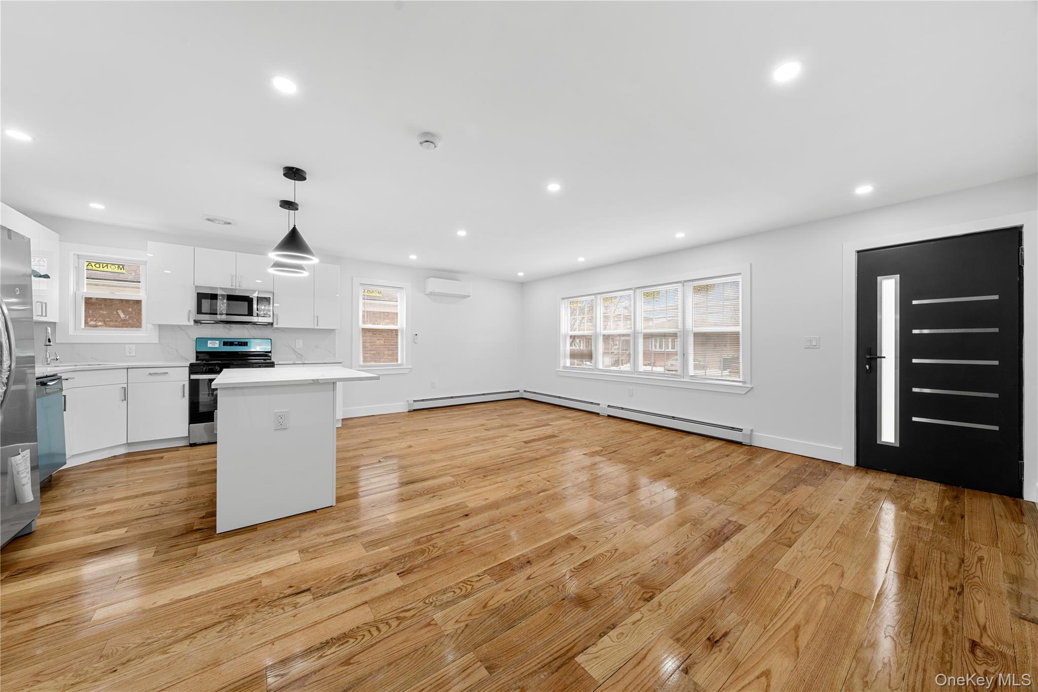 245-33 147th Road, Unit 1 Queens, NY 11422 - Photo 1 of 15 a view of an empty room with a window and wooden floor