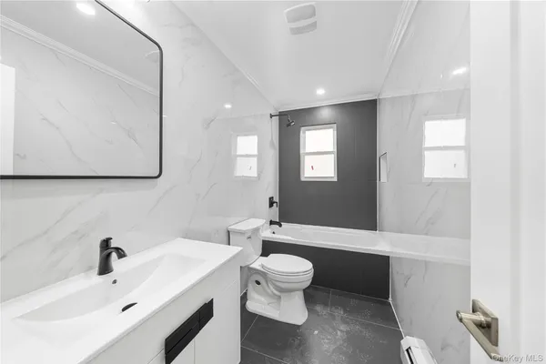 a bathroom with a sink a toilet and mirror