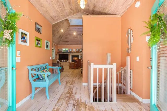 a view of a balcony with furniture and wooden floor