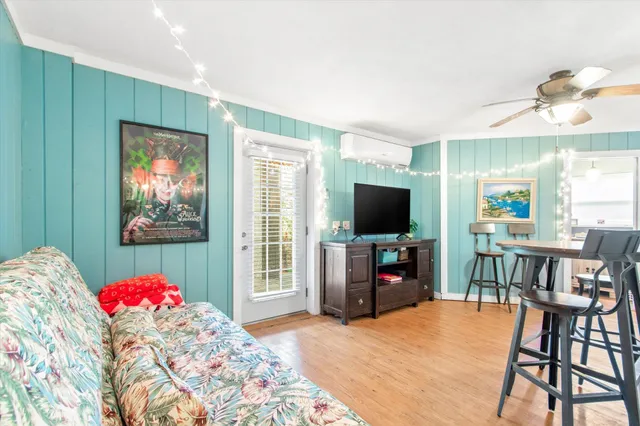a living room with furniture and a flat screen tv