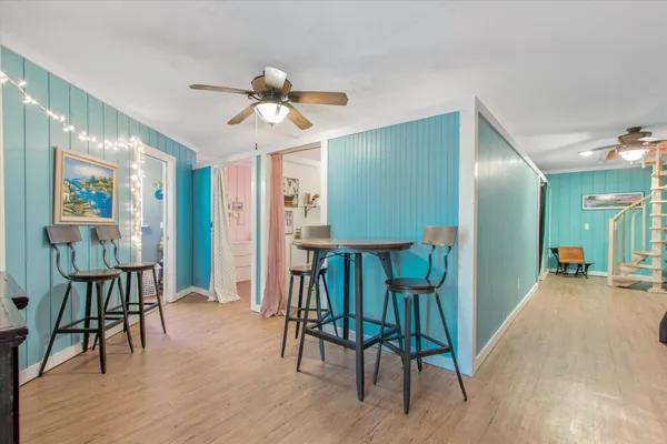 a view of a livingroom kitchen and dinning room with wooden floor