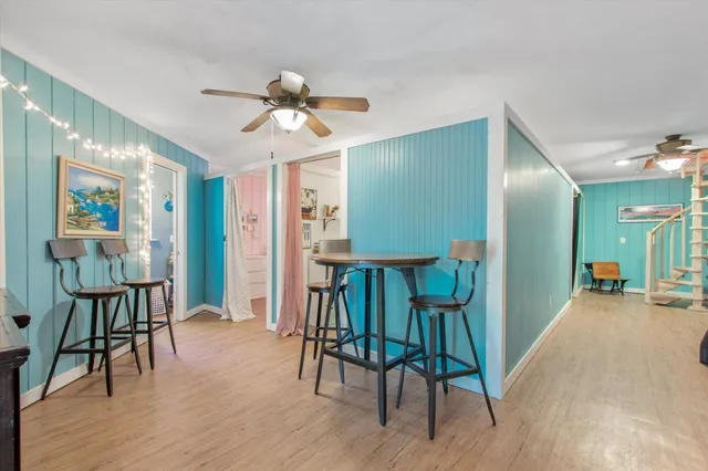 a view of a livingroom kitchen and dinning room with wooden floor