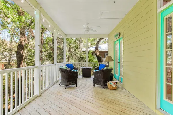 a view of roof deck with wooden floor and furniture