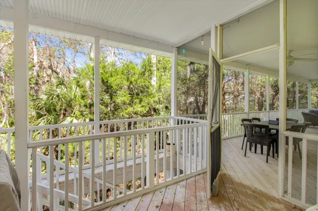 a view of a room with wooden floor and furniture