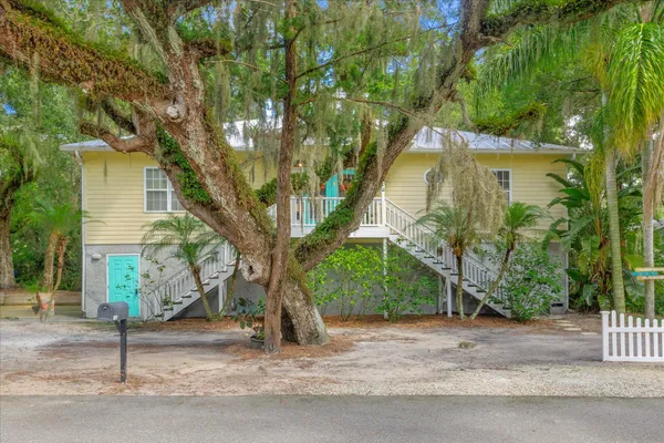 a house that has a tree in front of it