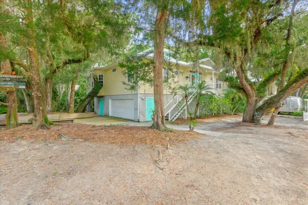 a view of a house with a yard and tree