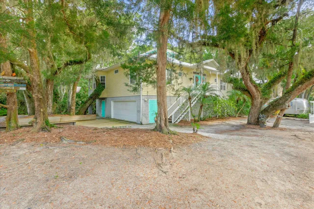 a view of a house with a yard and tree