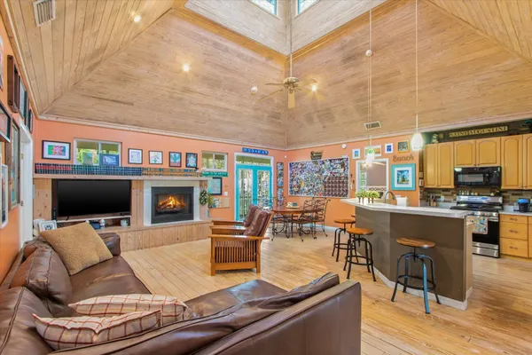 a living room with fireplace furniture and a flat screen tv