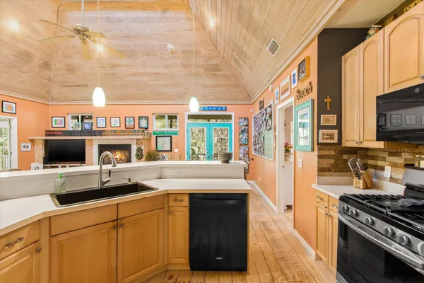 a kitchen with stainless steel appliances a stove and a microwave
