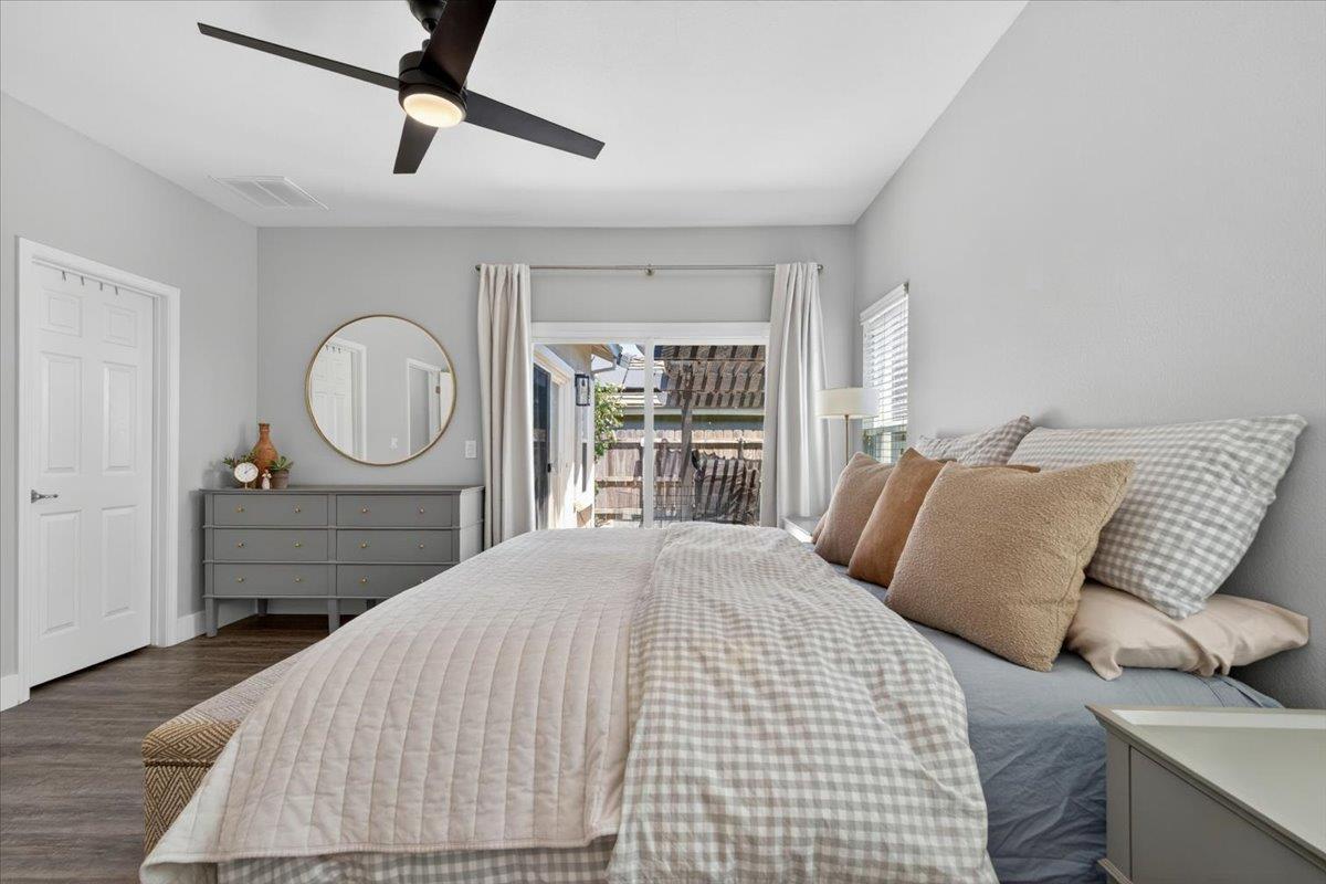 437 Silver Ridge Court Oakdale, CA 95361 - Photo 19 of 41 a bedroom with a bed a mirror and a large window
