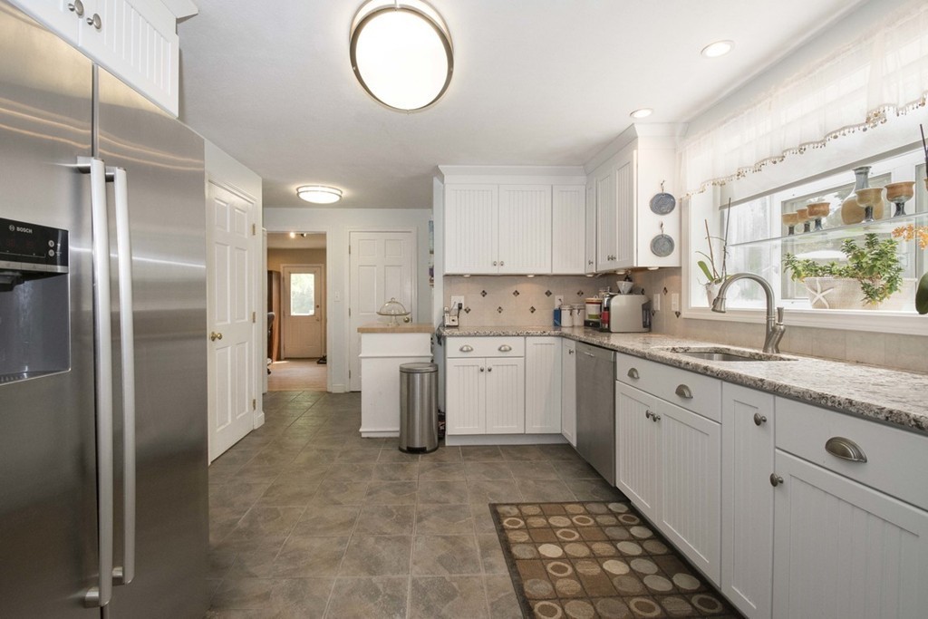 7 Jackson Road Scituate, MA 02066 - Photo 5 of 24 a kitchen with granite countertop a sink stove and refrigerator