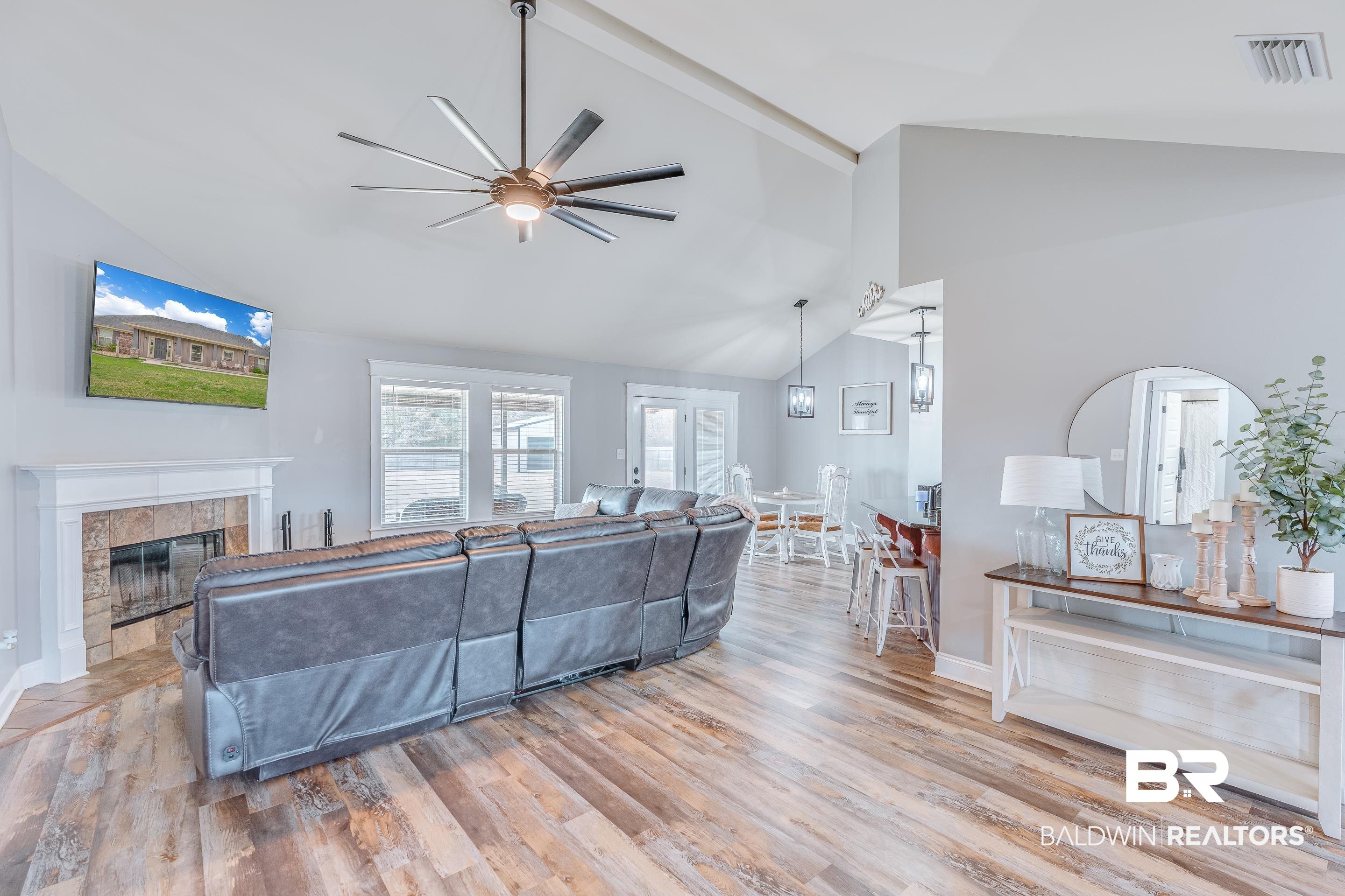 13235 Tom Gaston Road Mobile, AL 36695 - Photo 6 of 43 Living room featuring high vaulted ceiling, light hardwood / wood-style floors, a tile fireplace, and ceiling fan