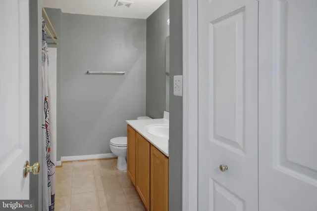 a bathroom with a granite countertop sink