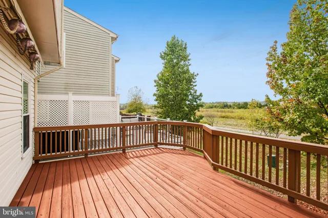 a view of deck with wooden floor and fence and a floor to ceiling window