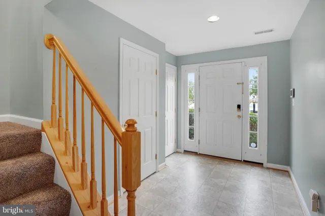 a view of a livingroom with wooden floor and stairs