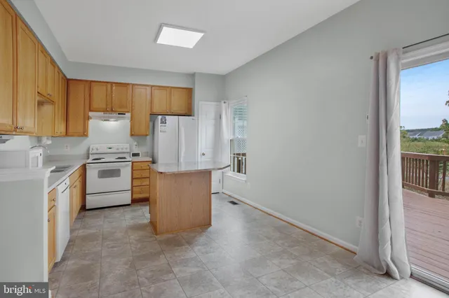 a kitchen with a stove top oven and cabinets