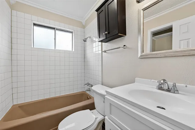 a bathroom with a sink a toilet and bathtub