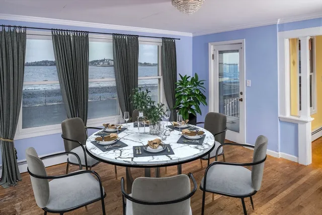 a view of a dining room with furniture window and wooden floor