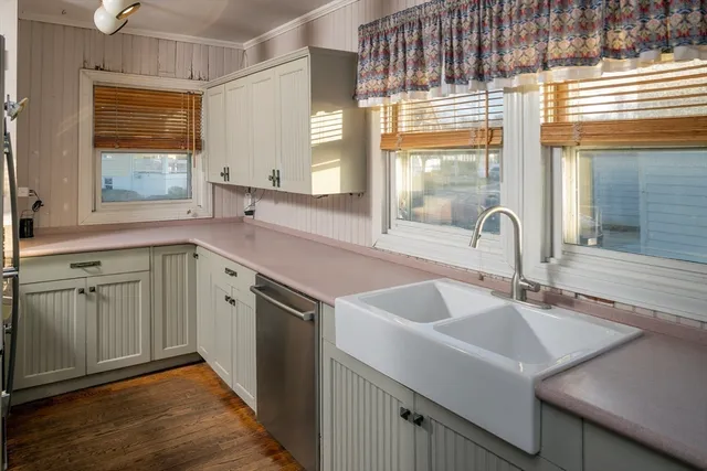 a kitchen with a sink cabinets and window