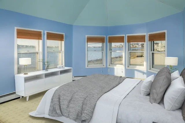 a bedroom with a large bed and a large window