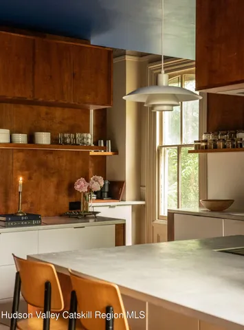 a kitchen with kitchen island a stove a sink and a counter top space