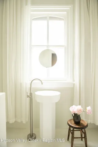 a backyard of a house with table and chairs and potted plants