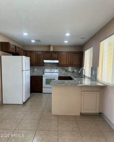 a view of a kitchen with a sink and a fireplace