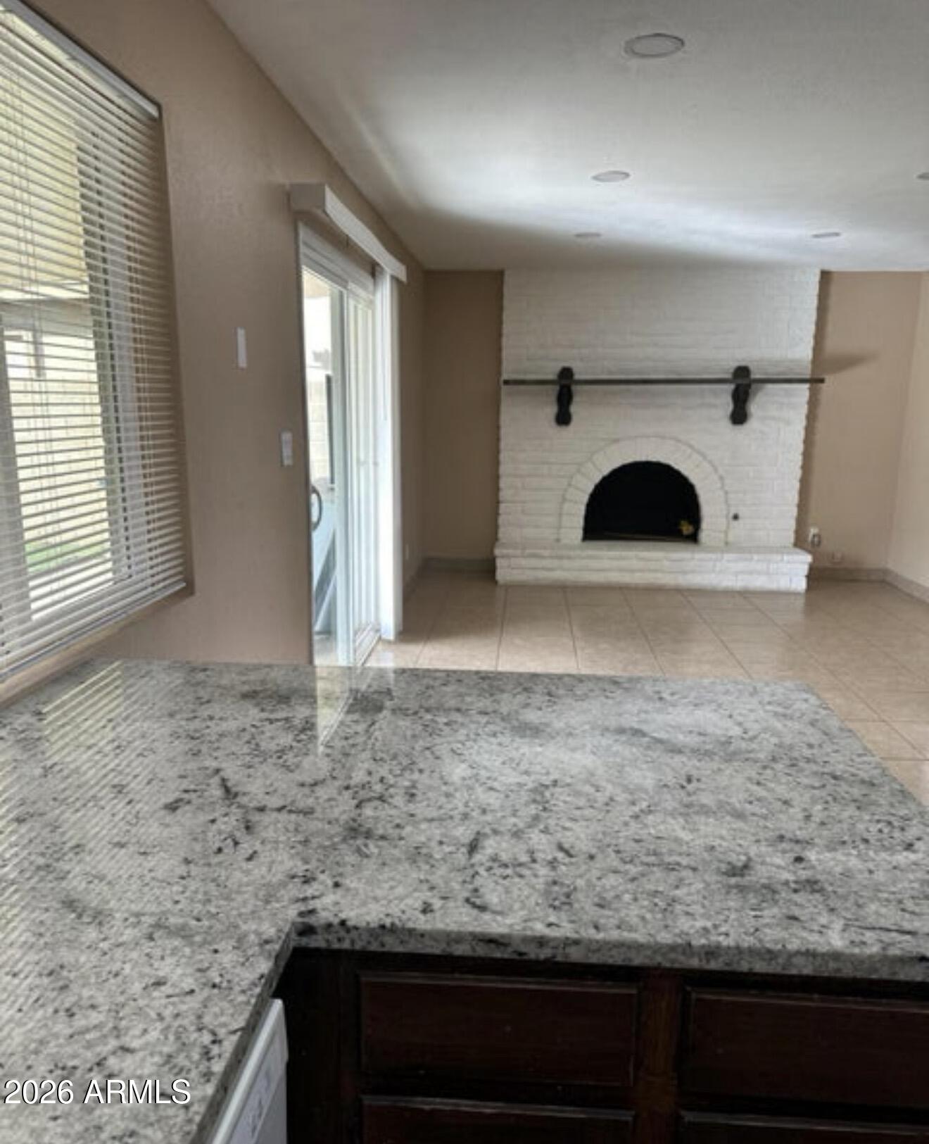 2916 North 87th Lane Phoenix, AZ 85037 - Photo 8 of 16 a view of a kitchen with a sink and a fireplace