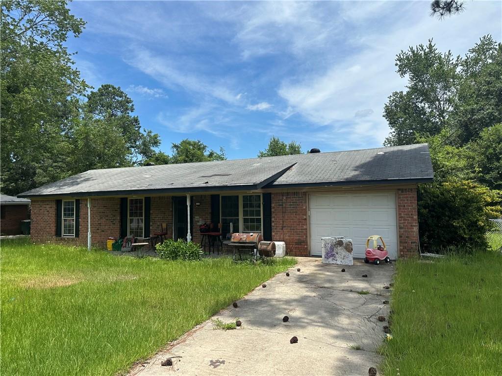 662 Mahoney Road Hinesville, GA 31313 - Photo 1 of 1 a backyard of a house with table and chairs plants and large tree