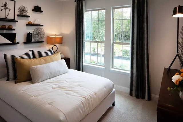 a bedroom with a bed and a window