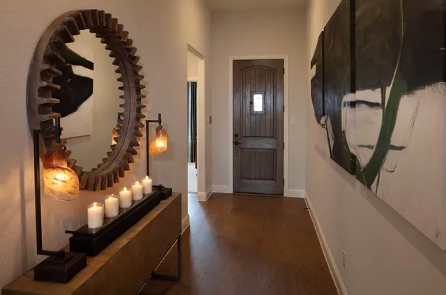 a view of a living room with furniture and entryway
