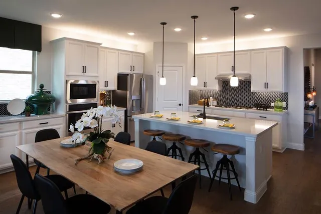 a spacious bedroom with a bed and a chandelier
