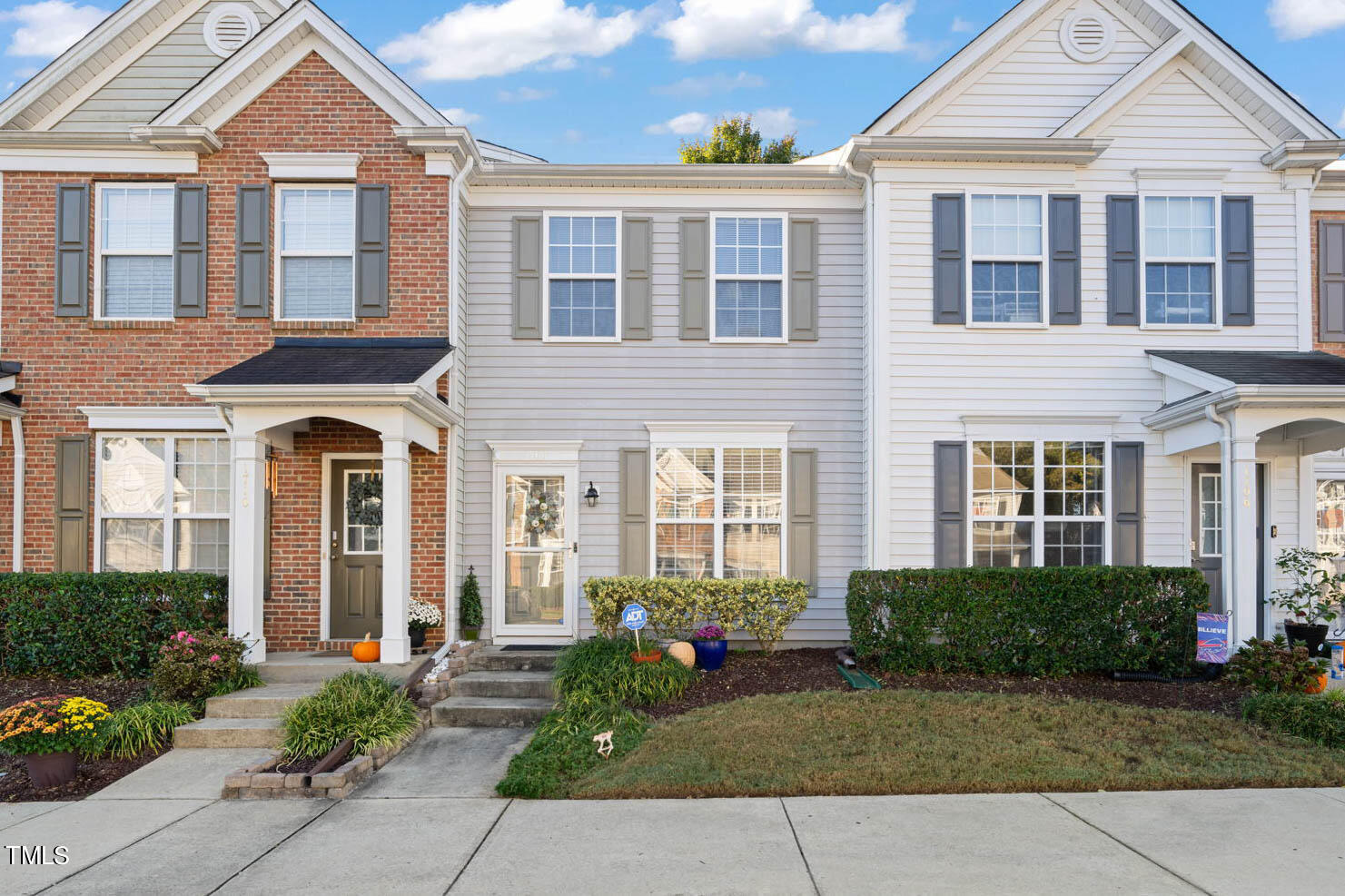 1708 Sorrell Brook Way Raleigh, NC 27609 - Photo 1 of 36 front view of a brick house with a yard