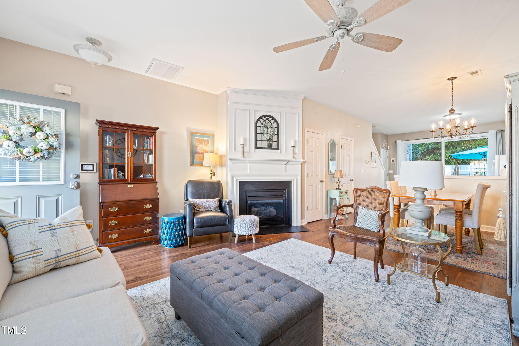 1708 Sorrell Brook Way Raleigh, NC 27609 - Photo 3 of 36 a living room with furniture a fireplace and a chandelier