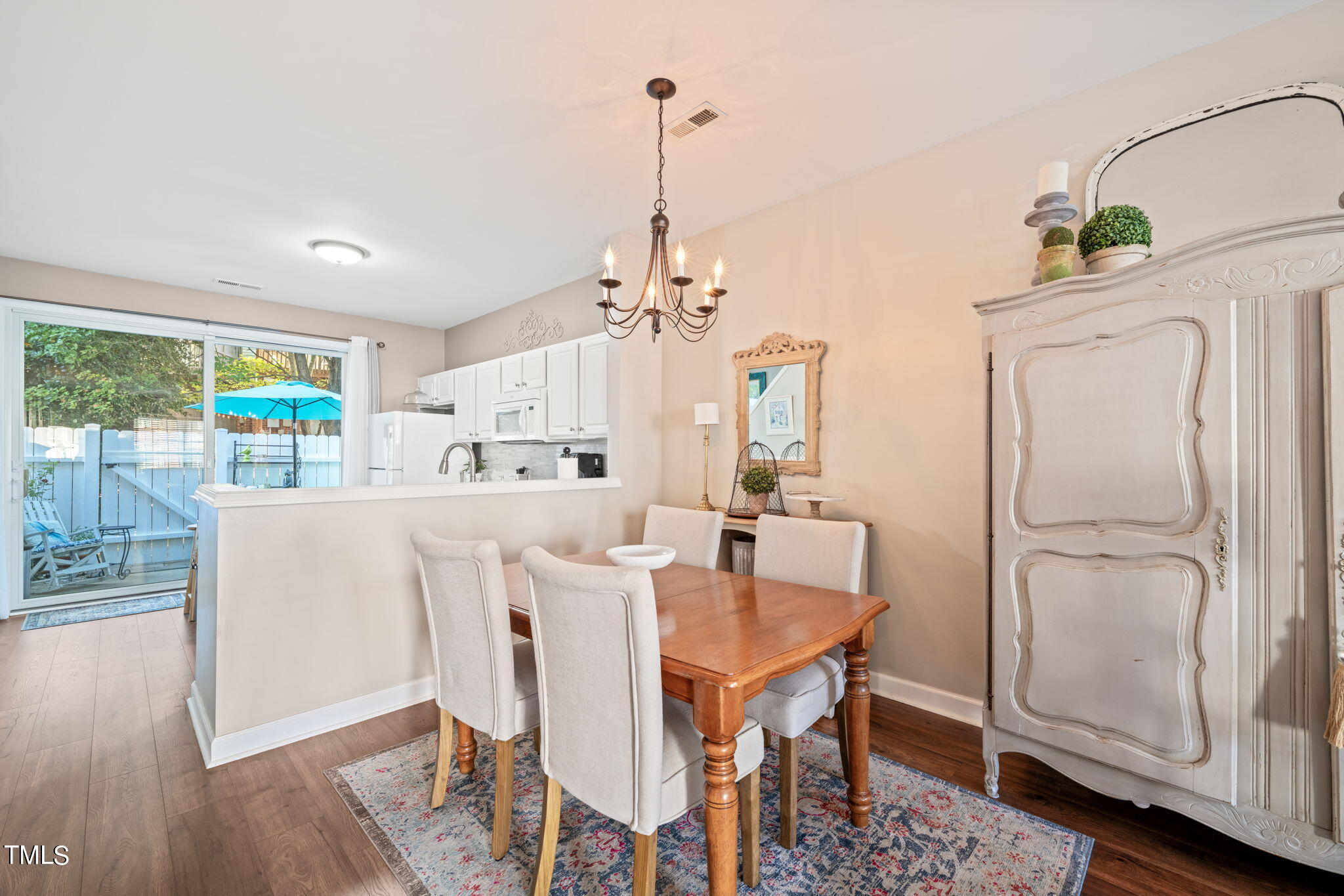 1708 Sorrell Brook Way Raleigh, NC 27609 - Photo 6 of 36 a dining room with furniture a chandelier and wooden floor