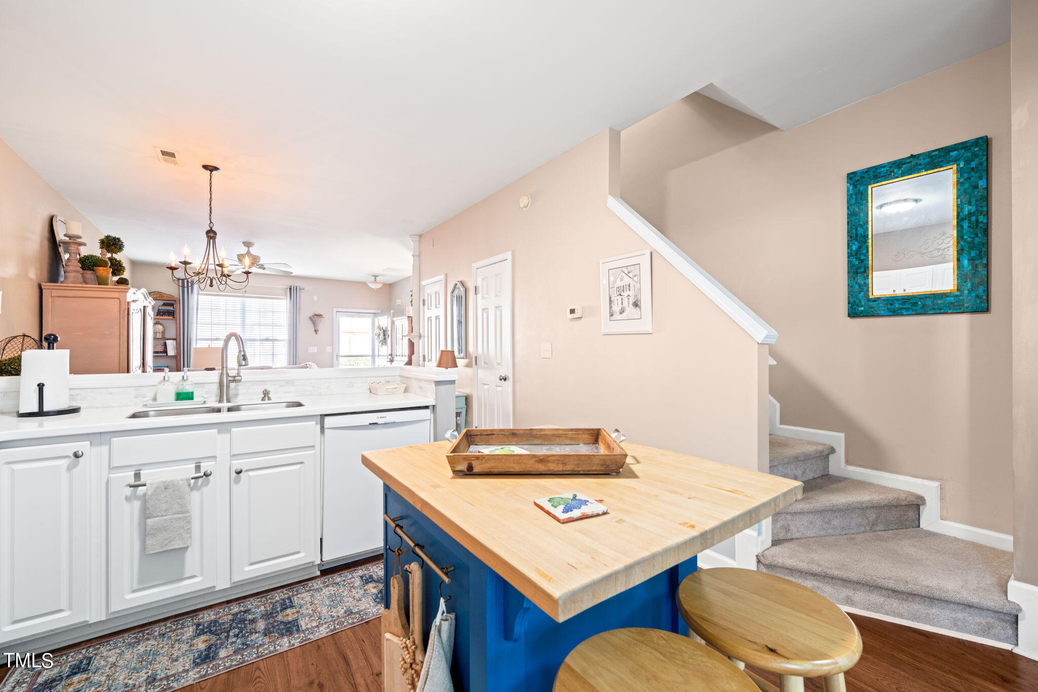1708 Sorrell Brook Way Raleigh, NC 27609 - Photo 10 of 36 a kitchen with a table chairs and white cabinets