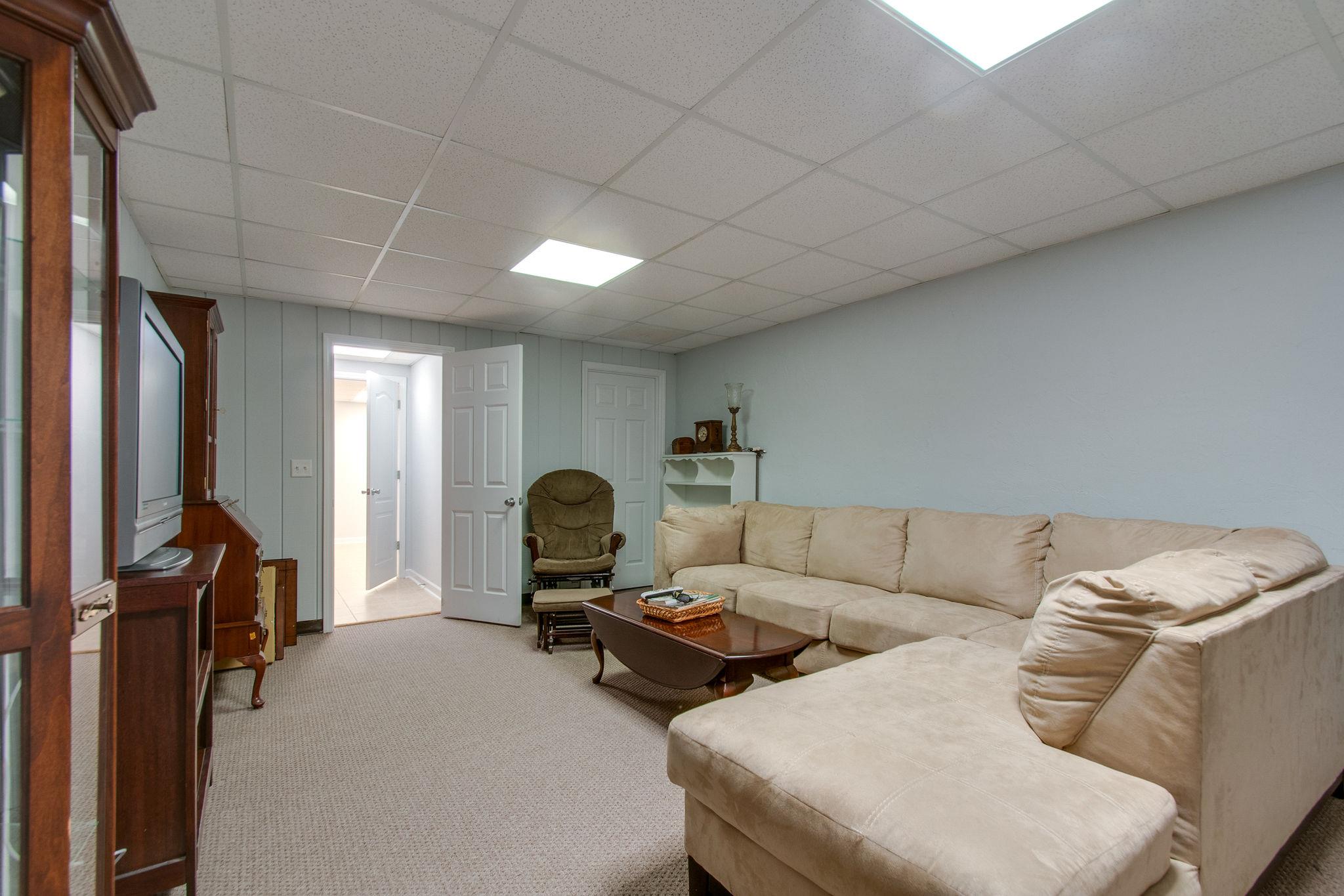 1452 White Bluff Road White Bluff, TN 37187 - Photo 22 of 28 Den in basement with garage access and a walk in closet.