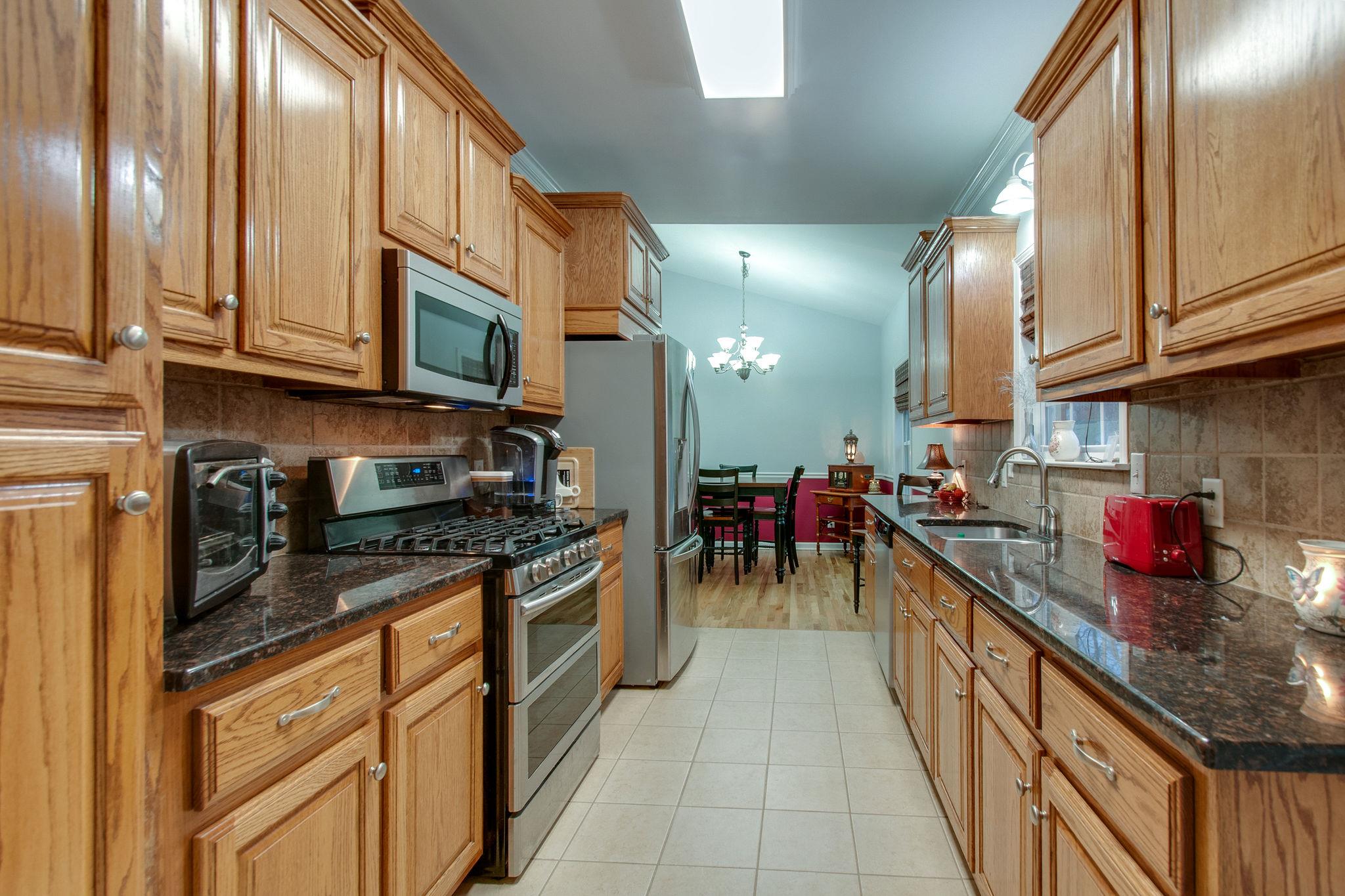 1452 White Bluff Road White Bluff, TN 37187 - Photo 9 of 28 Custom cabinetry, gas stove, stainless steel appliances and the refrigerator can stay.
