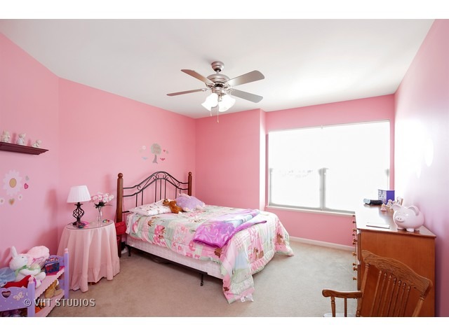 322 Monument Road Elgin, IL 60124 - Photo 14 of 15 a bedroom with a bed and a chandelier