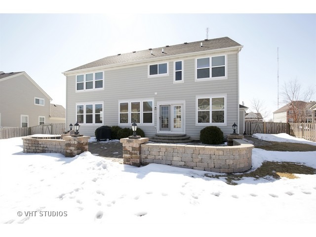 322 Monument Road Elgin, IL 60124 - Photo 15 of 15 a view of a house with a yard covered in snow