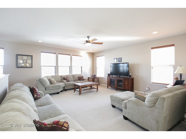 322 Monument Road Elgin, IL 60124 - Photo 8 of 15 a living room with furniture and a flat screen tv