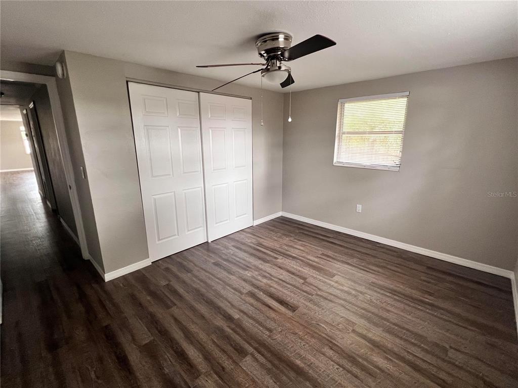 5650 Golden Nugget Drive Holiday, FL 34690 - Photo 8 of 9 wooden floor in an empty room with a window