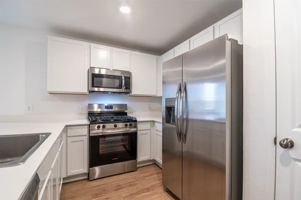 a kitchen with a stove microwave and refrigerator