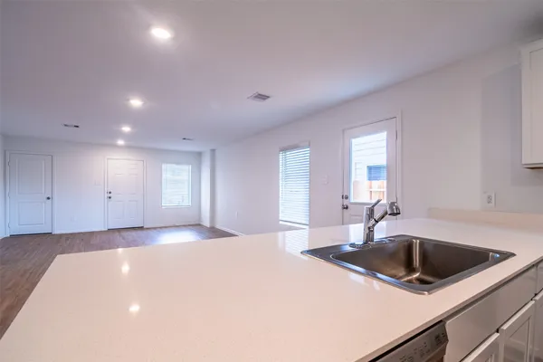 a kitchen with a sink and chandelier